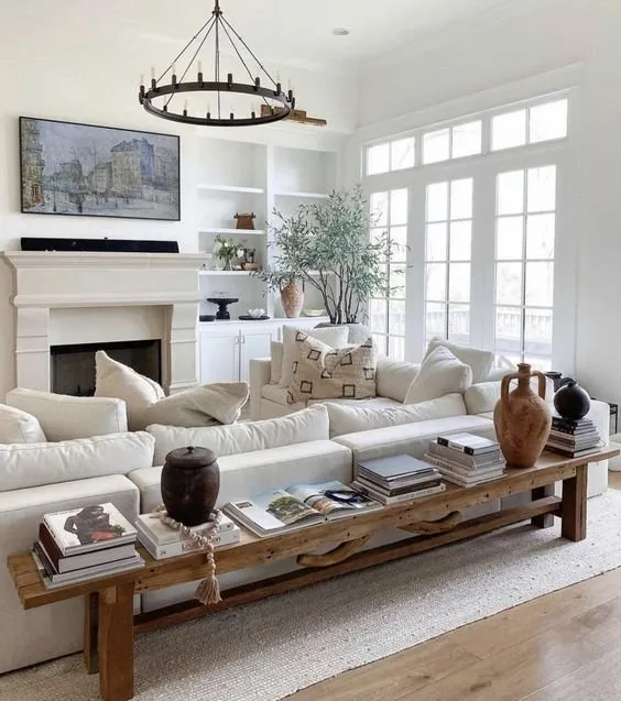 Bright lounge with a deep white sofa and a long wooden console table