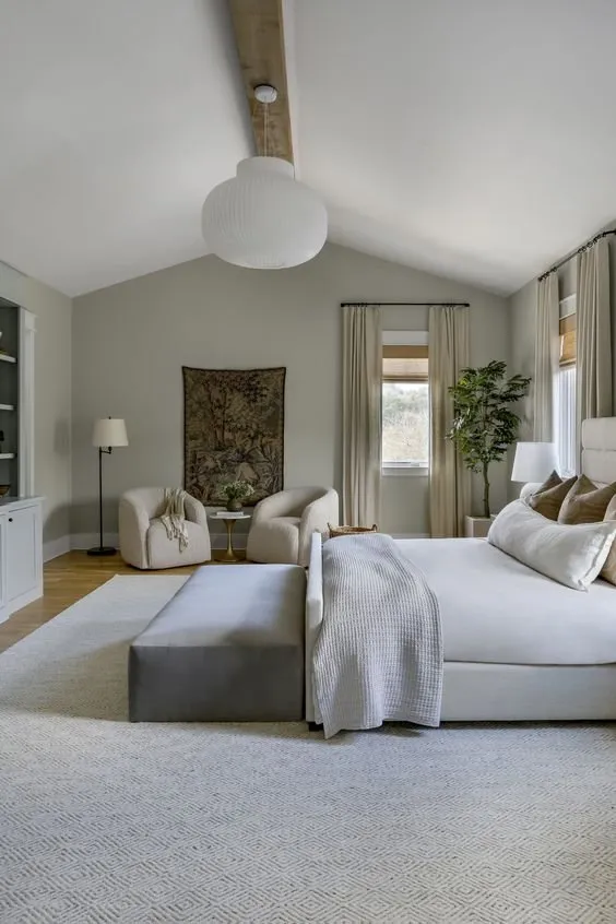 Calm bedroom in soft neutrals with a vaulted ceiling